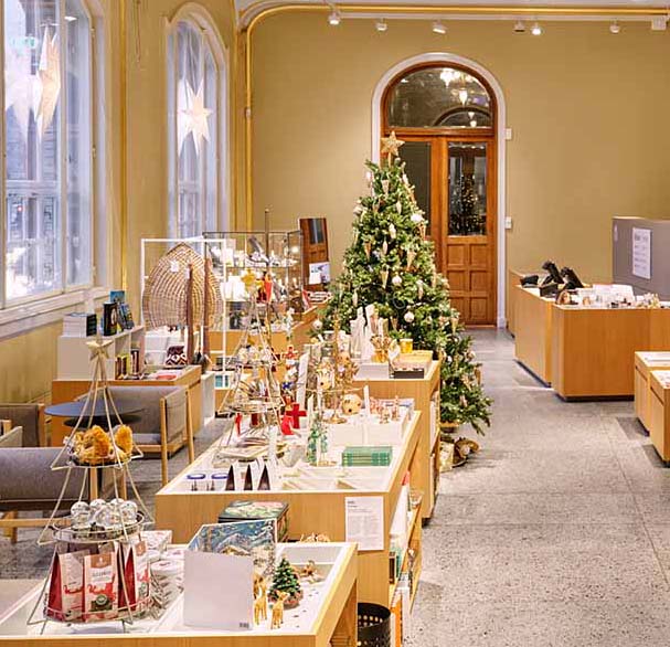 A view of a christmas decorated museum shop. 