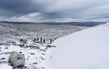 Archaeologists stand at the discovery site.