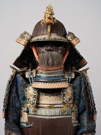 The face was protected by a mask with a detachable nose piece. Moustaches made of the bristle of wild boar, or the hair of yaks or horses made the masks look fierce and frightening.
