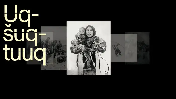 Black and white photo of a woman carrying a child in her anorak.
